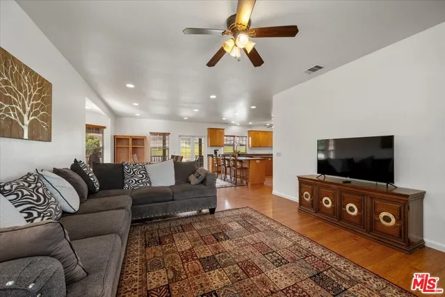 a kitchen with stainless steel appliances granite countertop a sink a stove and refrigerator