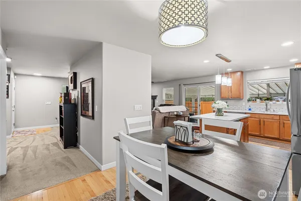 a kitchen with a refrigerator and a stove top oven