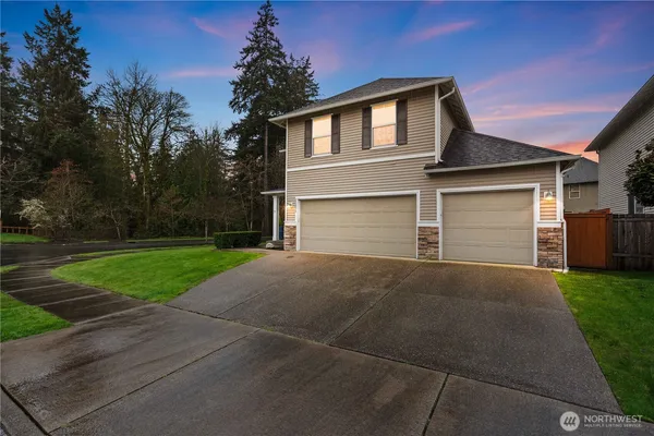 a front view of a house with a yard and garage