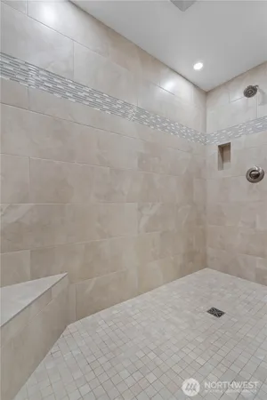 a spacious bathroom with a double vanity sink a mirror and a bathtub