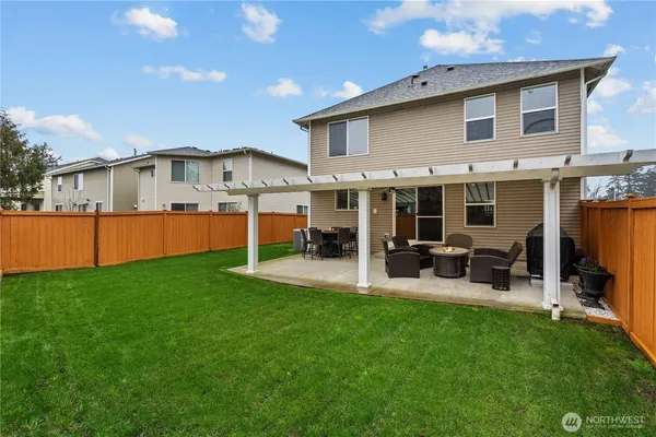 a front view of house with yard and outdoor seating