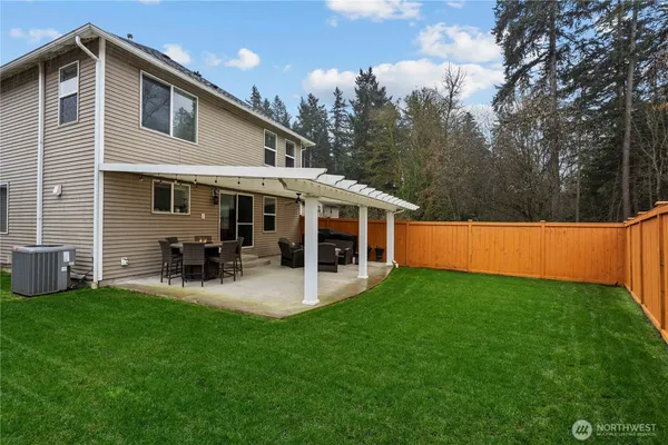 a view of a house with backyard porch and sitting area