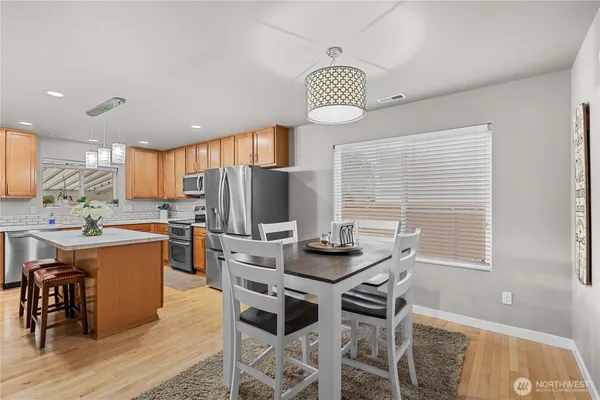 a living room with kitchen island furniture and a chandelier