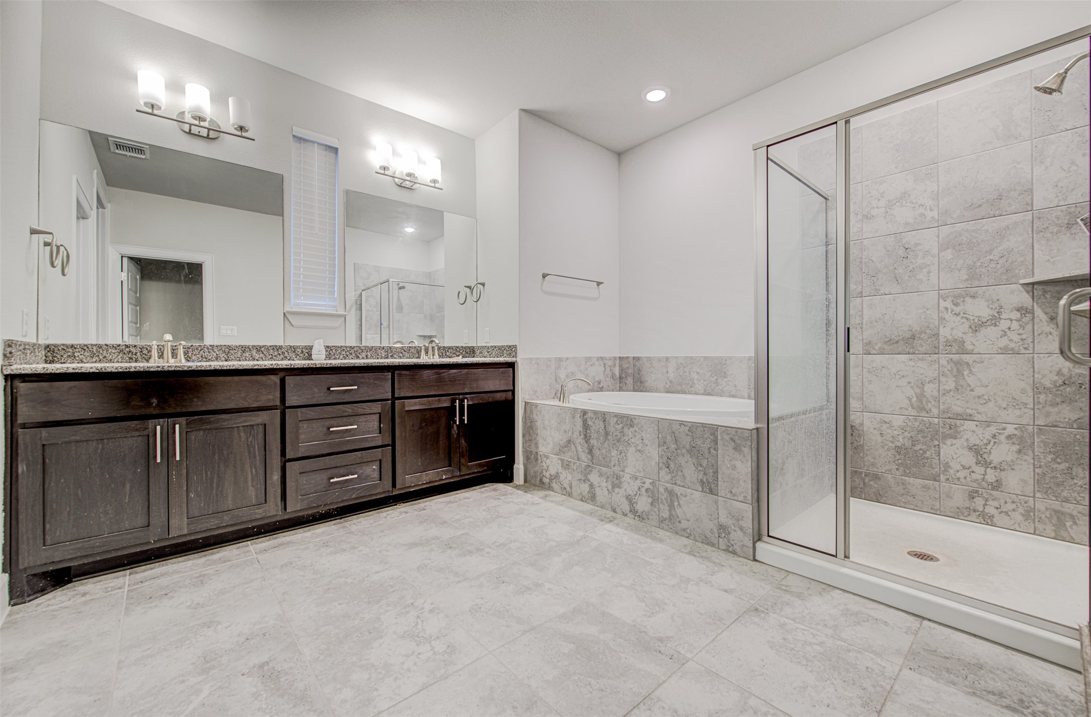 316 Buffalo Ridge Drive Manchaca, TX 78652 - Photo 15 of 37 a spacious bathroom with a tub sink shower and mirror