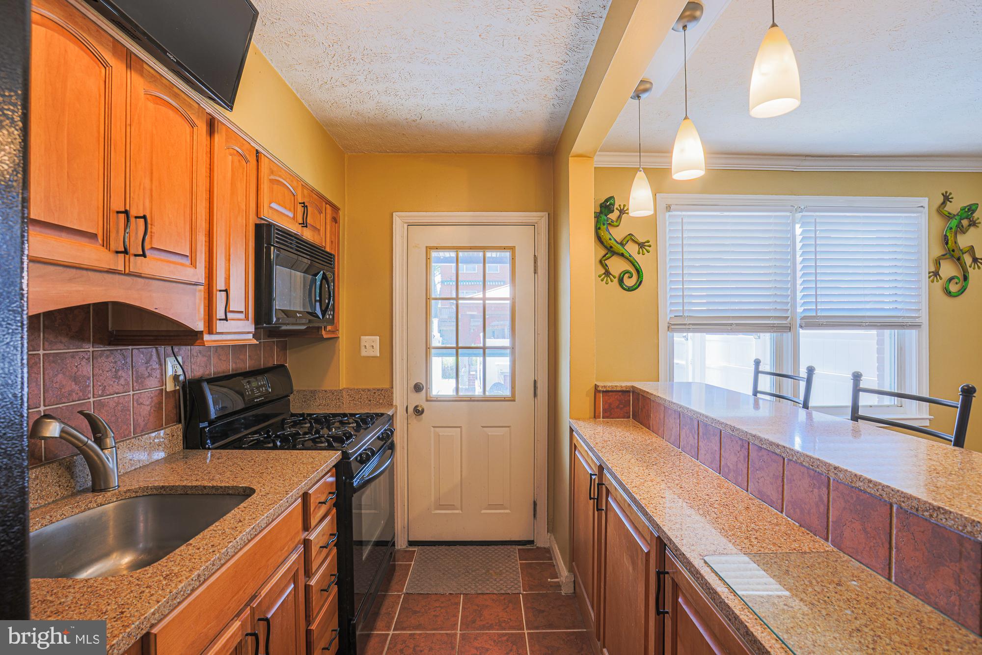 8343 Hillendale Road Baltimore, MD 21234 - Photo 16 of 35 a kitchen that has a sink and a stove