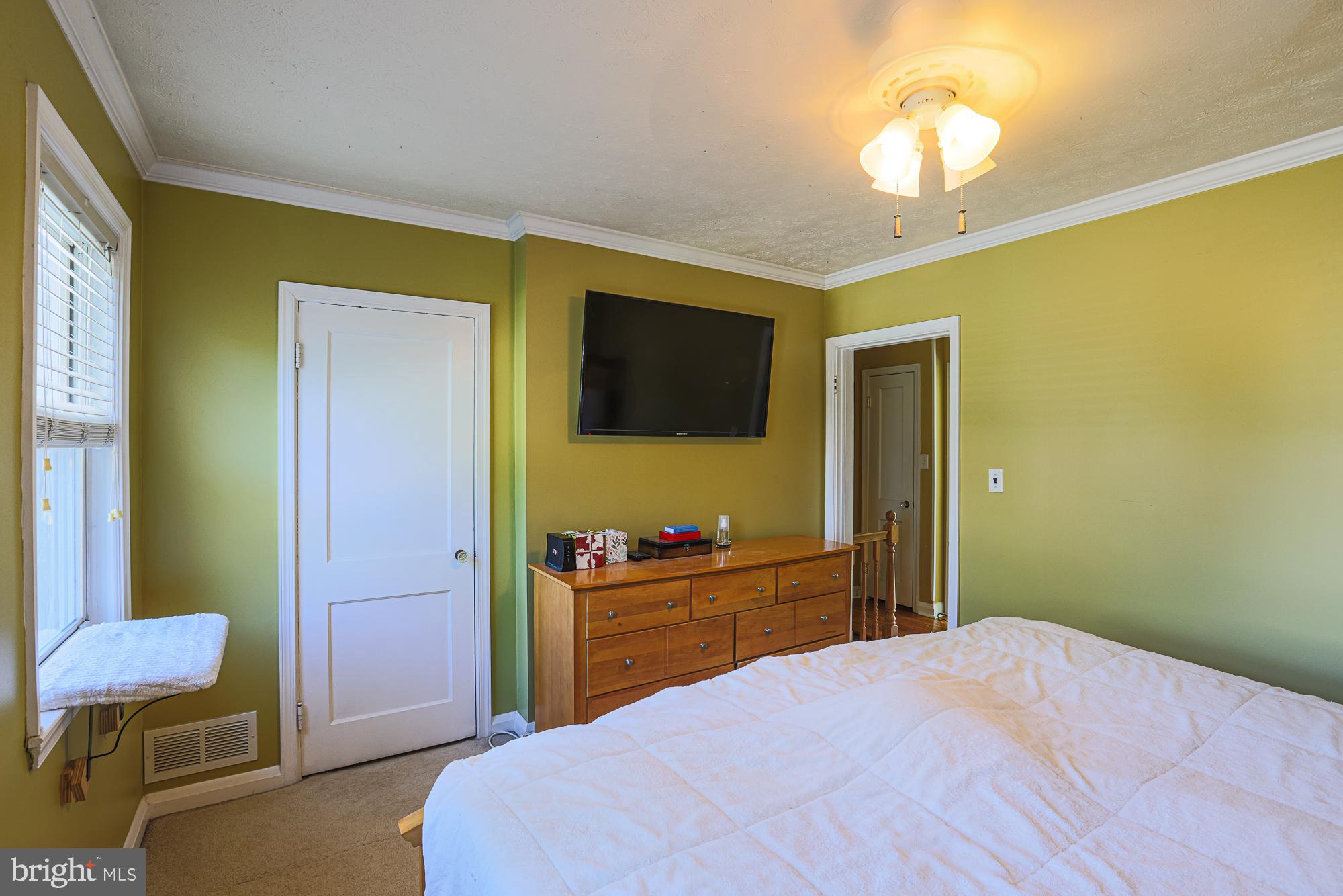 8343 Hillendale Road Baltimore, MD 21234 - Photo 20 of 35 a bedroom with a bed and a chandelier