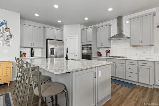 a kitchen with stainless steel appliances granite countertop a sink stove and refrigerator