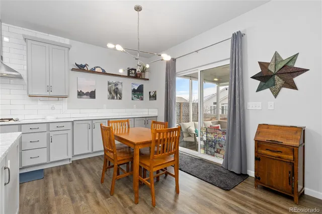 a living room with furniture a rug and a floor to ceiling window