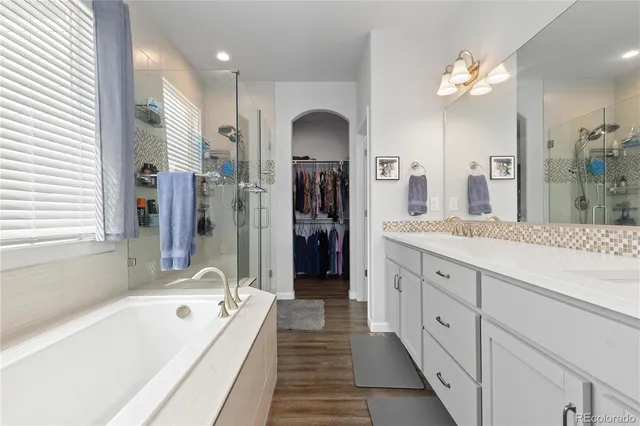 a bathroom with a tub sink and glass door