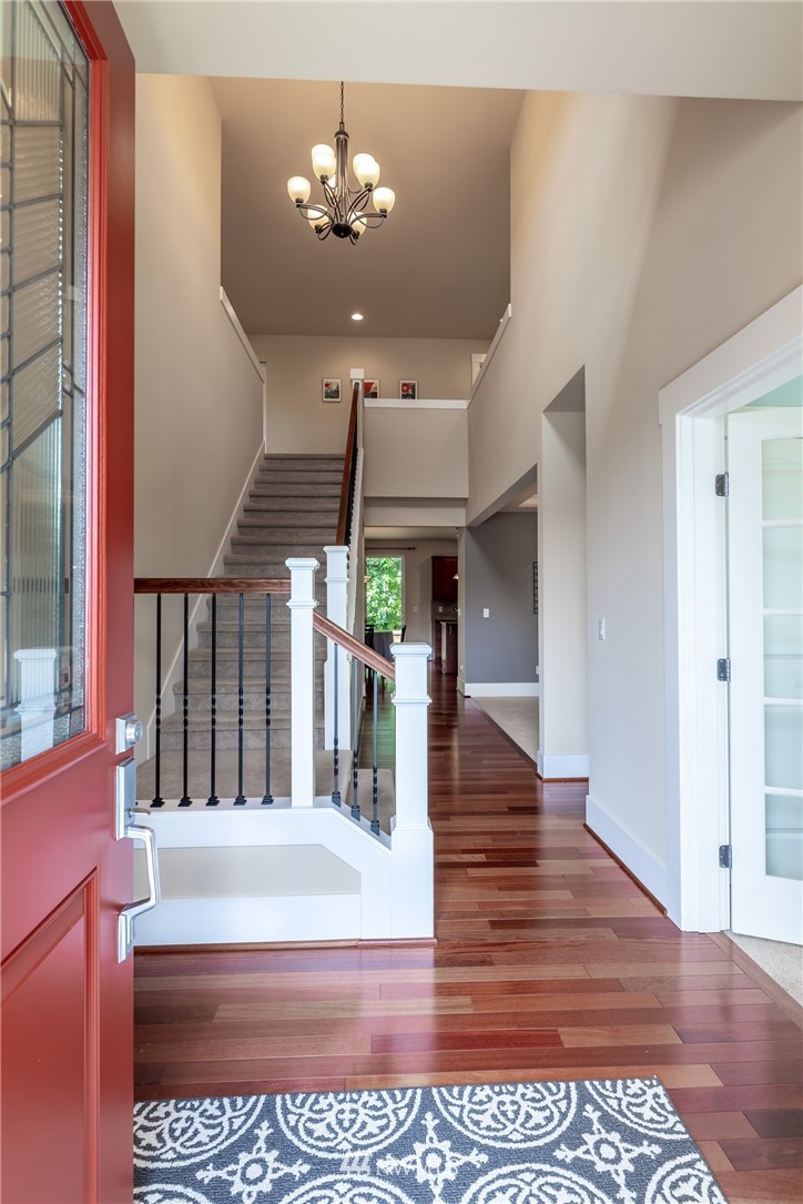 5204 Northeast 9th Place Renton, WA 98059 - Photo 2 of 33 a view of a hallway with wooden floor and stairs