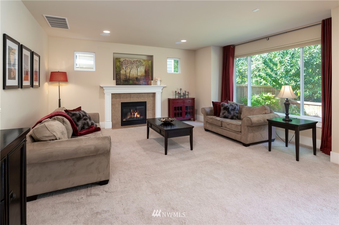 5204 Northeast 9th Place Renton, WA 98059 - Photo 12 of 33 a living room with furniture and a fireplace
