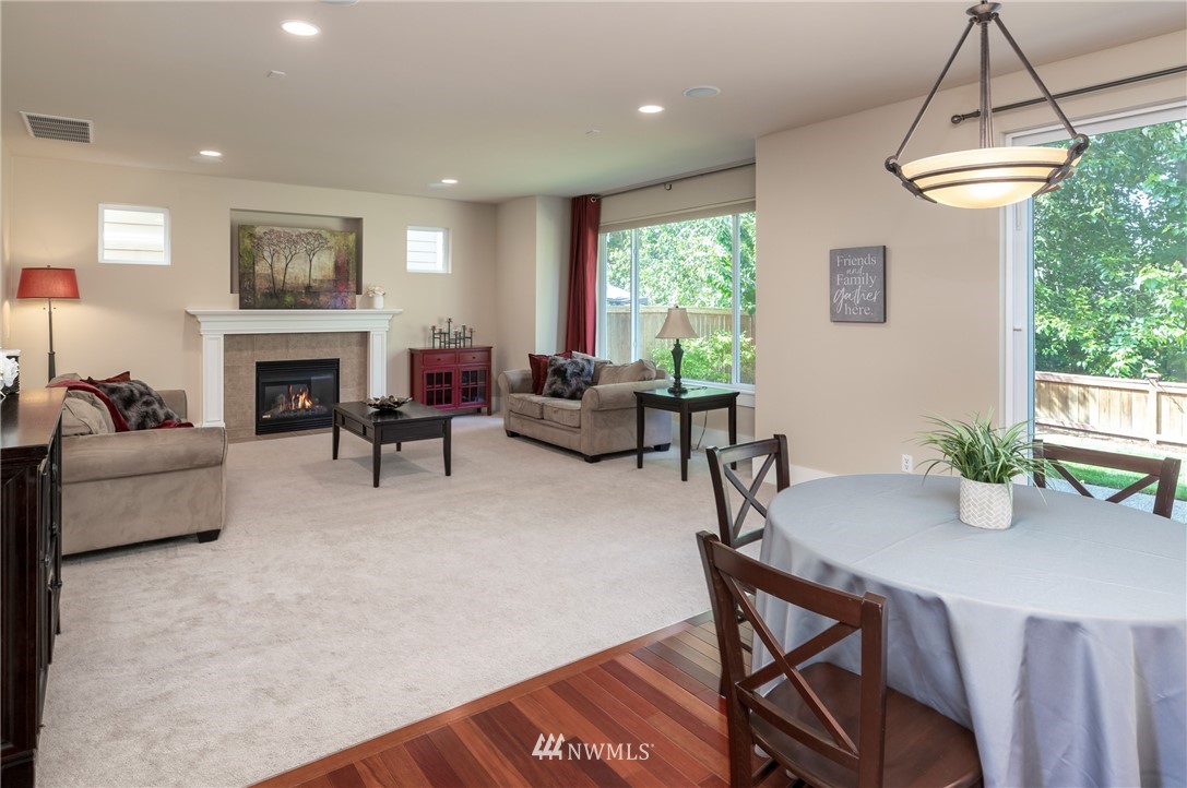 5204 Northeast 9th Place Renton, WA 98059 - Photo 14 of 33 a living room with furniture a fireplace and a potted plant