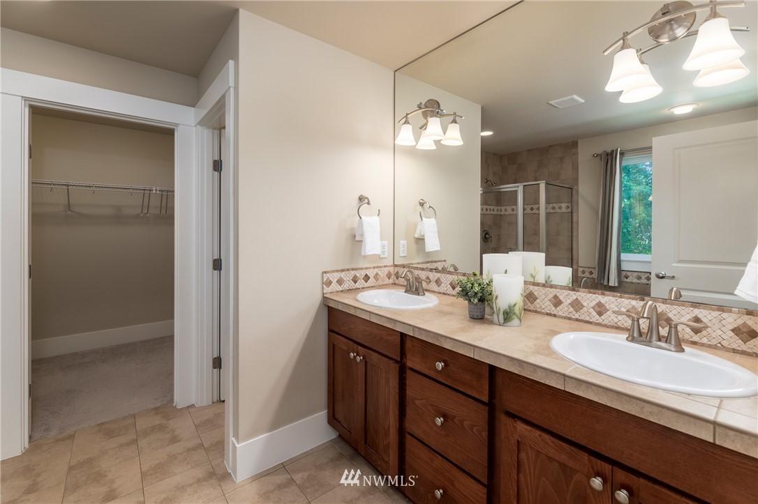 5204 Northeast 9th Place Renton, WA 98059 - Photo 20 of 33 a bathroom with a double vanity sink and mirror