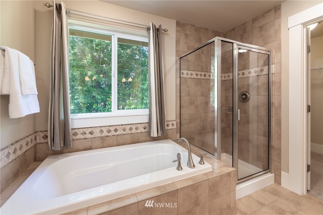 5204 Northeast 9th Place Renton, WA 98059 - Photo 21 of 33 a bathroom with a bathtub and a shower