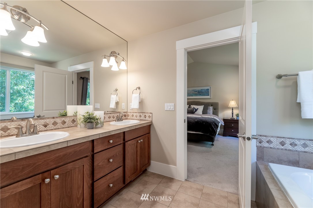 5204 Northeast 9th Place Renton, WA 98059 - Photo 22 of 33 a en suite bathroom with double sink and a mirror