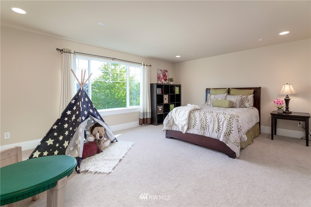 5204 Northeast 9th Place Renton, WA 98059 - Photo 23 of 33 a bedroom with a bed and a large window