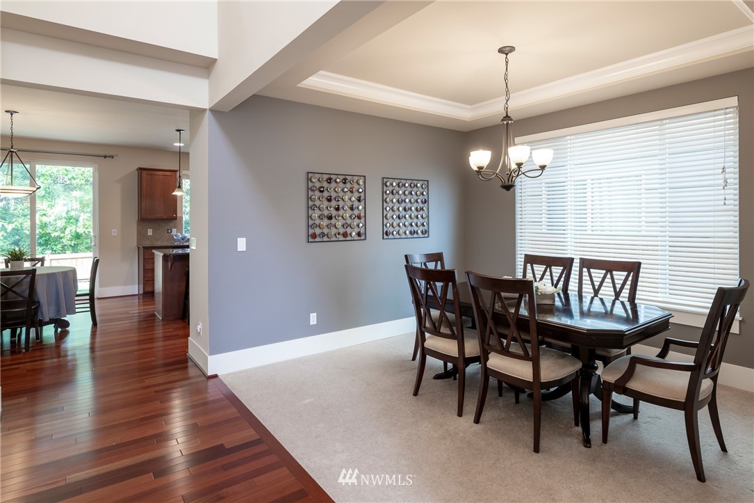 5204 Northeast 9th Place Renton, WA 98059 - Photo 5 of 33 a dining room with furniture a chandelier and wooden floor