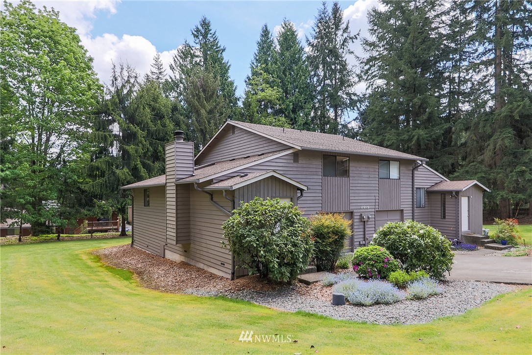 17215 Gravenstein Road Bothell, WA 98012 - Photo 1 of 13 a view of a house with backyard and trees