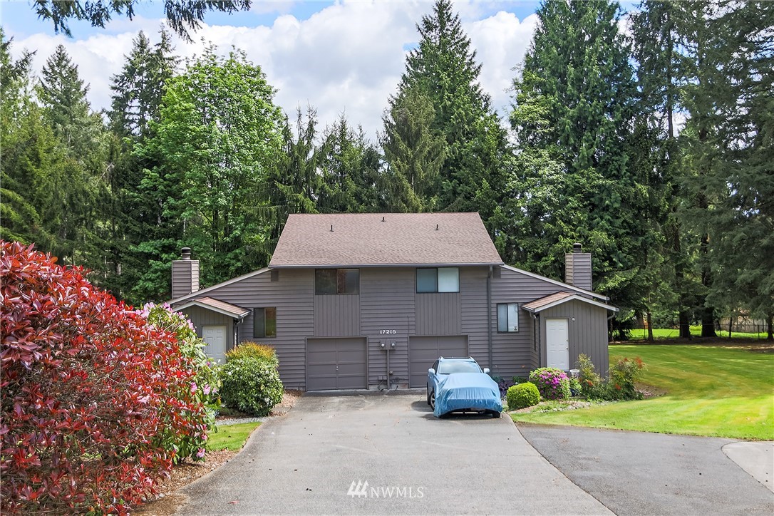 17215 Gravenstein Road Bothell, WA 98012 - Photo 2 of 13 a front view of a house with a yard and garage