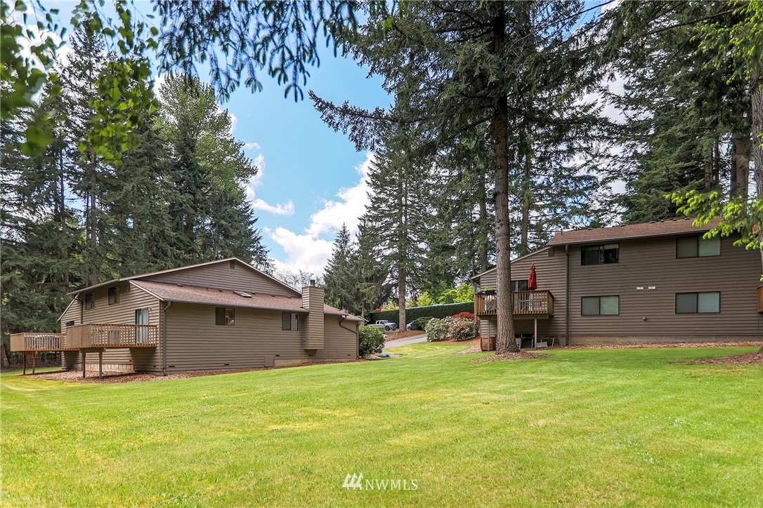 17215 Gravenstein Road Bothell, WA 98012 - Photo 12 of 13 a front view of house with yard and trees in the background