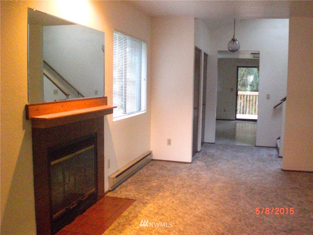 17215 Gravenstein Road Bothell, WA 98012 - Photo 7 of 13 a view of an empty room with glass door and a window