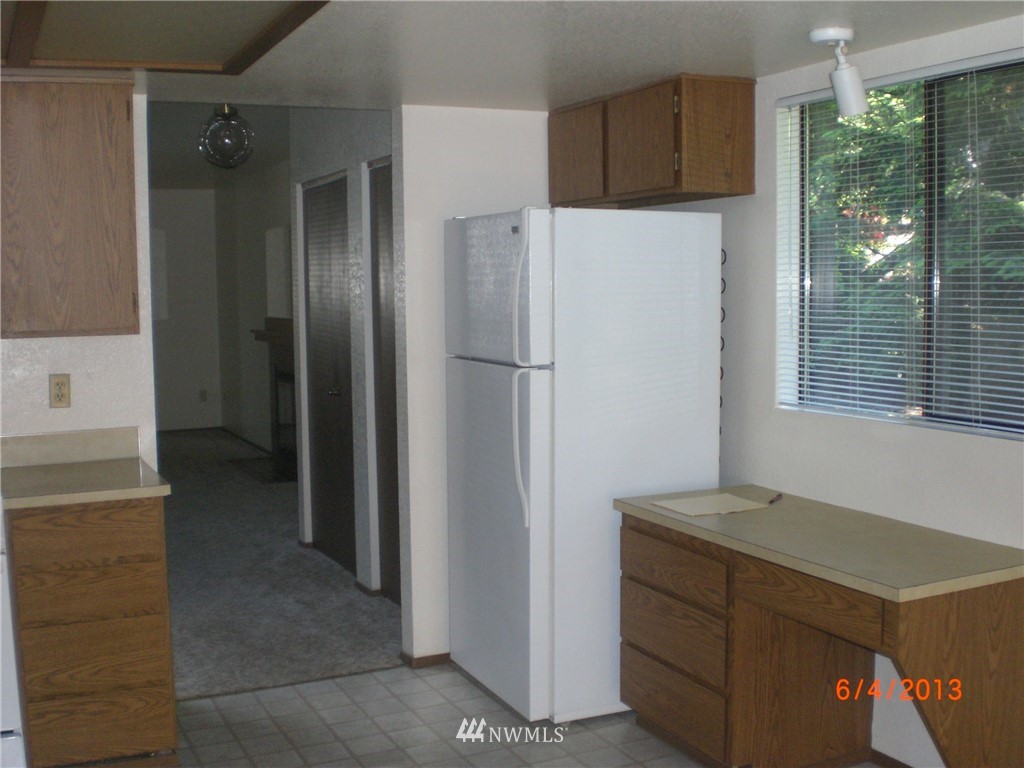17215 Gravenstein Road Bothell, WA 98012 - Photo 9 of 13 a kitchen with a refrigerator and a stove