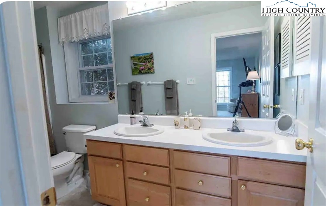 304 St Andrews Road Beech Mountain, NC 28604 - Photo 16 of 33 a bathroom with a toilet sink and mirror