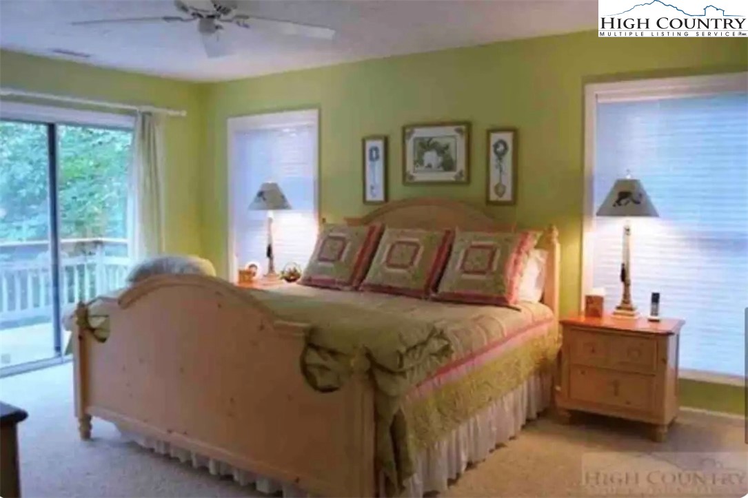 304 St Andrews Road Beech Mountain, NC 28604 - Photo 21 of 33 a bed room with a bed and a chandelier
