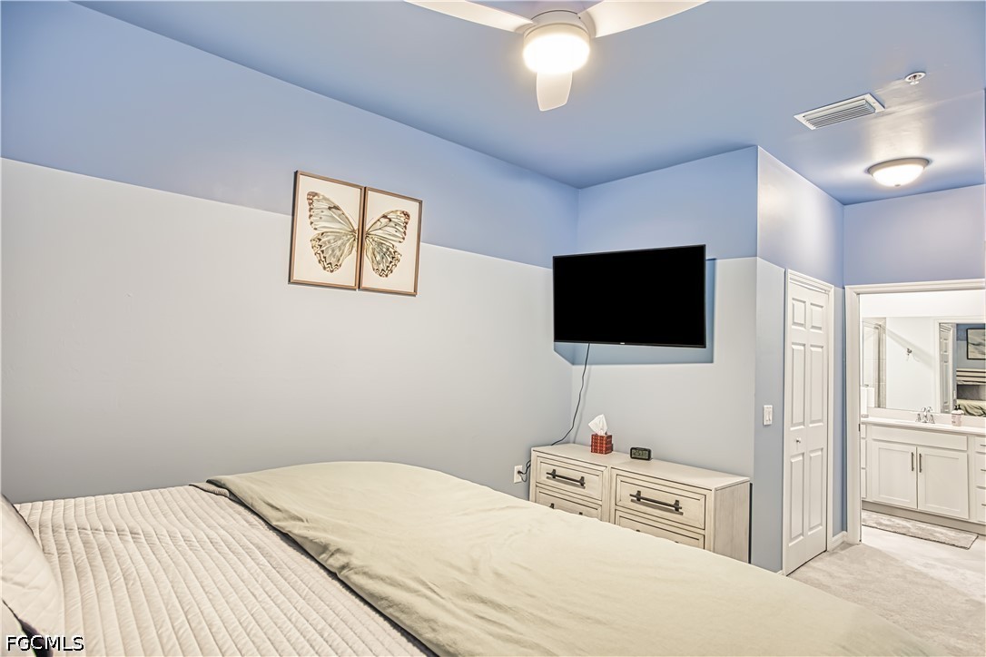 43993 Boardwalk Loop, Unit 1941 Punta Gorda, FL 33982 - Photo 4 of 36 a bedroom with a bed and a flat screen tv