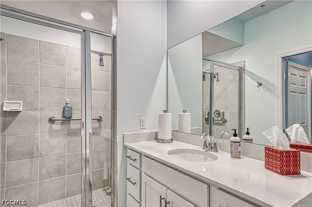 43993 Boardwalk Loop, Unit 1941 Punta Gorda, FL 33982 - Photo 7 of 36 a bathroom with a double vanity sink mirror and shower