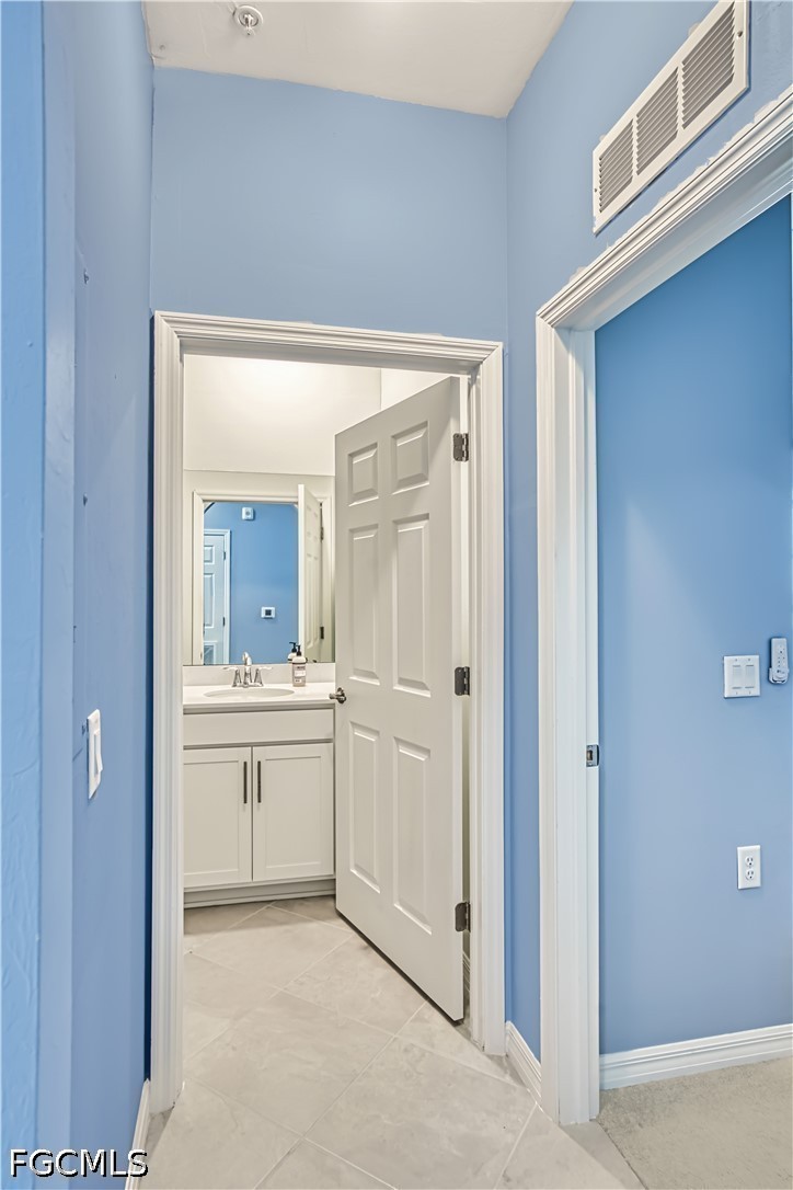 43993 Boardwalk Loop, Unit 1941 Punta Gorda, FL 33982 - Photo 8 of 36 a bathroom with a granite countertop sink mirror and vanity