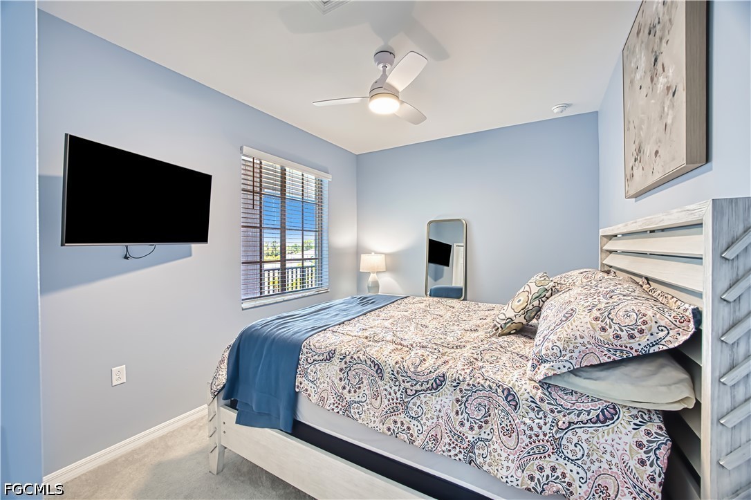 43993 Boardwalk Loop, Unit 1941 Punta Gorda, FL 33982 - Photo 10 of 36 a bedroom with a large bed and a flat screen tv