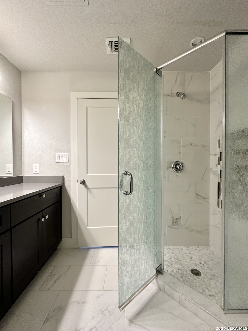 831 Terrell Road, Unit 103 San Antonio, TX 78209 - Photo 5 of 8 a bathroom with a shower and a sink
