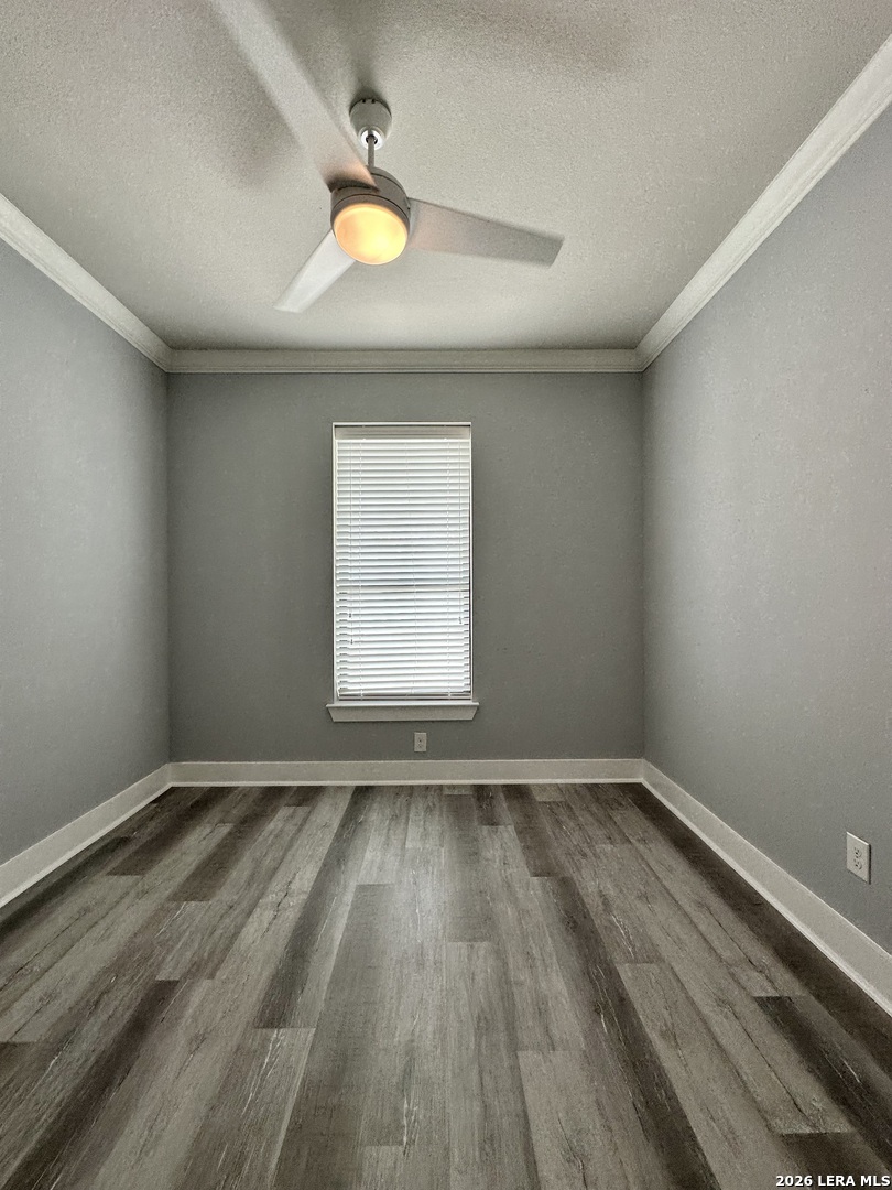 831 Terrell Road, Unit 103 San Antonio, TX 78209 - Photo 6 of 8 an empty room with wooden floor and windows