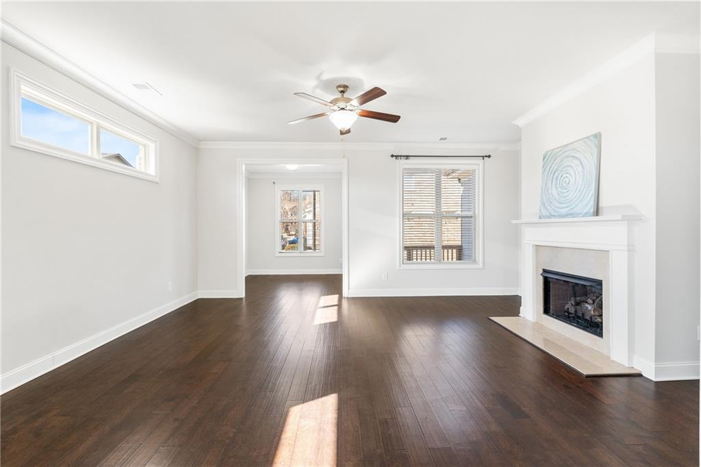 1002 Township Square Alpharetta, GA 30022 - Photo 15 of 42 a view of an empty room with wooden floor fireplace and a window