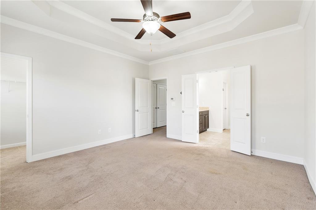 1002 Township Square Alpharetta, GA 30022 - Photo 27 of 42 an empty room with chandelier fan and ceiling fan
