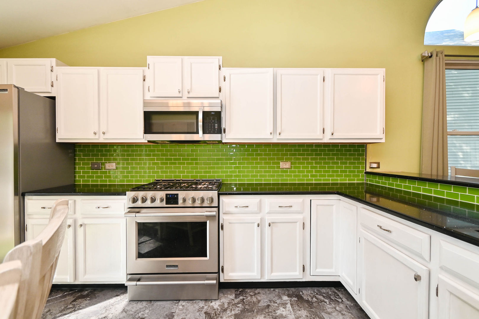 1333 Regency Lane Round Lake, IL 60073 - Photo 15 of 31 a kitchen with stainless steel appliances white cabinets and a stove top oven