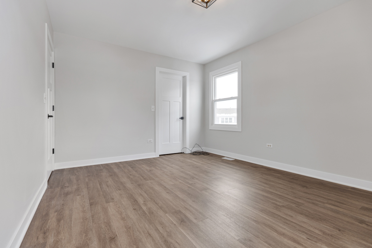 1066 Glouchester Harbor, Unit 1066 Schaumburg, IL 60193 - Photo 15 of 26 an empty room with wooden floor and window