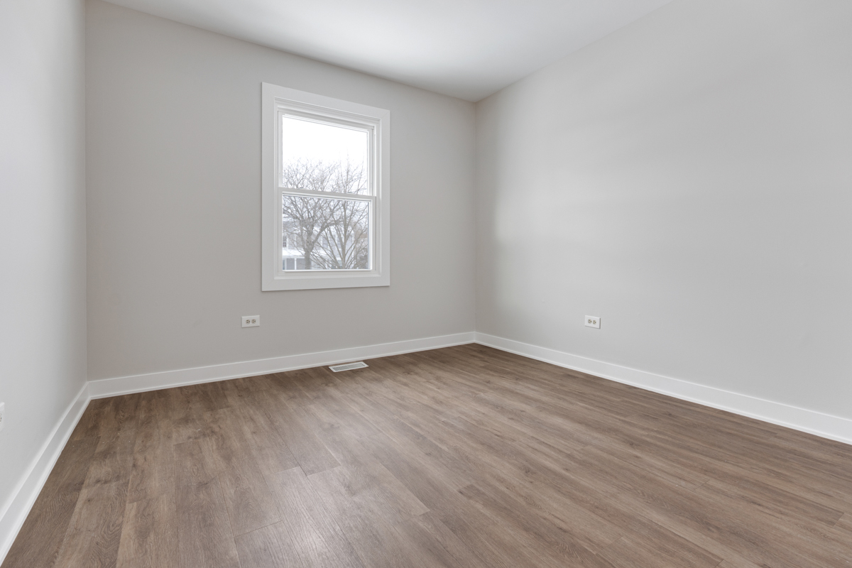 1066 Glouchester Harbor, Unit 1066 Schaumburg, IL 60193 - Photo 19 of 26 an empty room with wooden floor and window