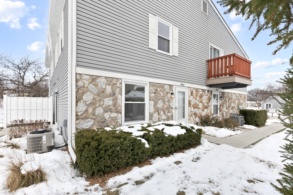 1066 Glouchester Harbor, Unit 1066 Schaumburg, IL 60193 - Photo 2 of 26 a view of a house with a yard covered in snow