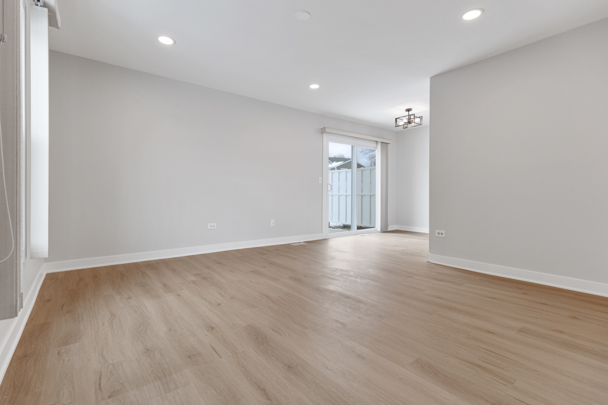 1066 Glouchester Harbor, Unit 1066 Schaumburg, IL 60193 - Photo 4 of 26 a view of an empty room with wooden floor