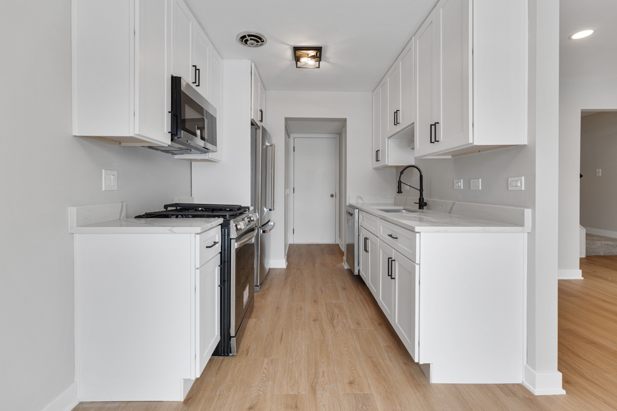 1066 Glouchester Harbor, Unit 1066 Schaumburg, IL 60193 - Photo 7 of 26 a kitchen with stainless steel appliances a white cabinets and a stove top oven