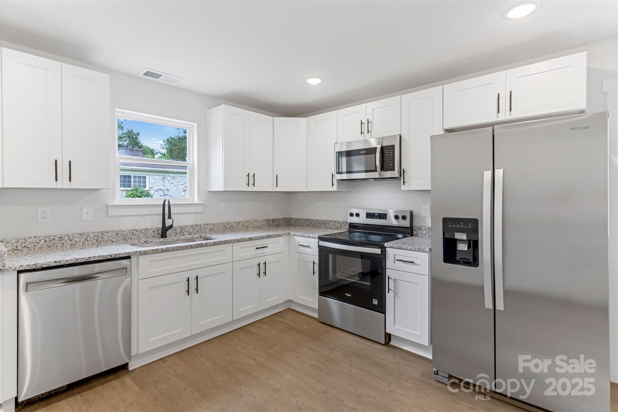 21 8th Ave Drive Southeast, Unit 5 Hickory, NC 28602 - Photo 2 of 14 a kitchen with stainless steel appliances granite countertop a refrigerator sink and stove