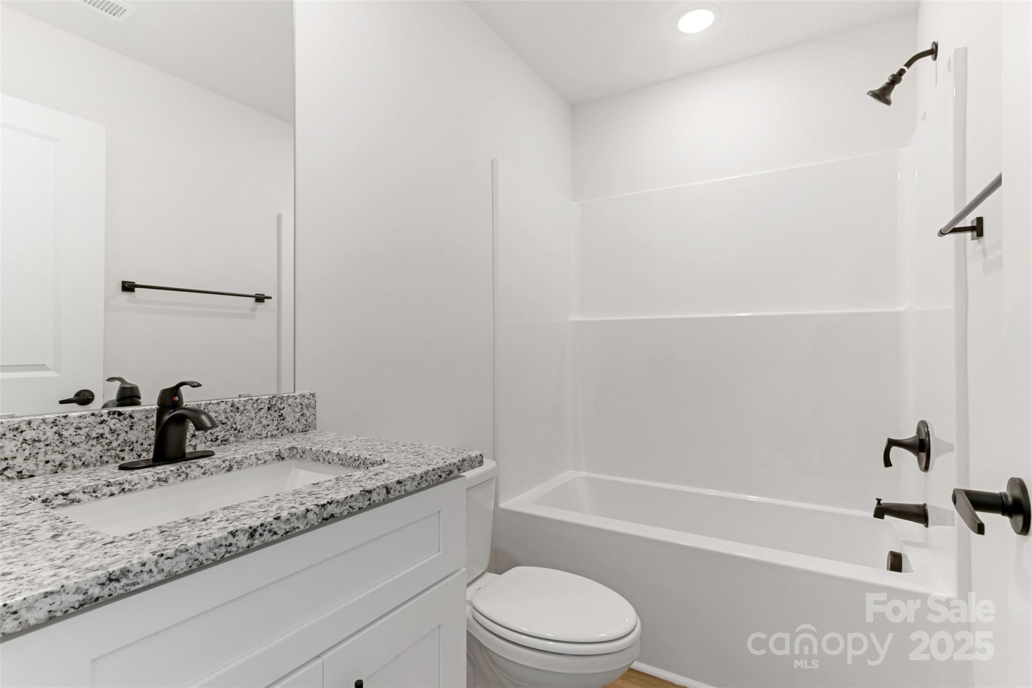 21 8th Ave Drive Southeast, Unit 5 Hickory, NC 28602 - Photo 9 of 14 a bathroom with a granite countertop sink a toilet and bathtub