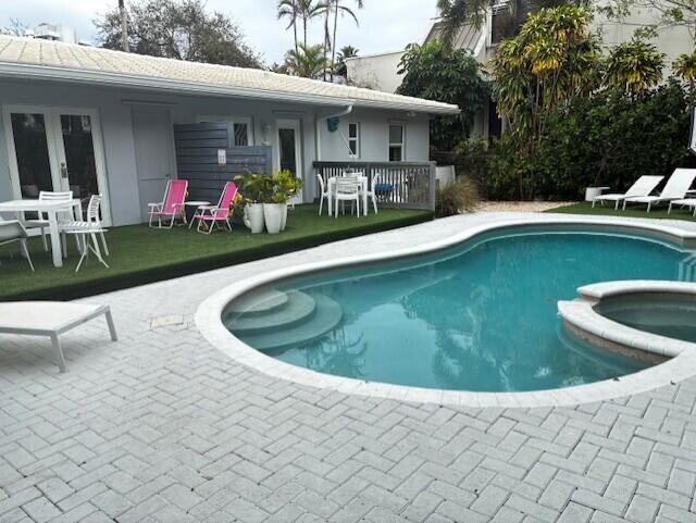 a view of a swimming pool with a patio