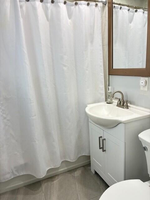 3414 Spring Street Pompano Beach, FL 33062 - Photo 13 of 14 a bathroom with a sink a toilet and a mirror