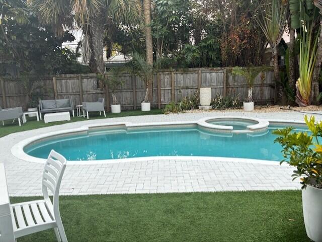 3414 Spring Street Pompano Beach, FL 33062 - Photo 2 of 14 a view of a swimming pool with a patio