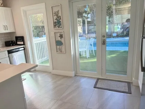 a kitchen with stainless steel appliances a refrigerator a sink a stove top oven a counter space and cabinets