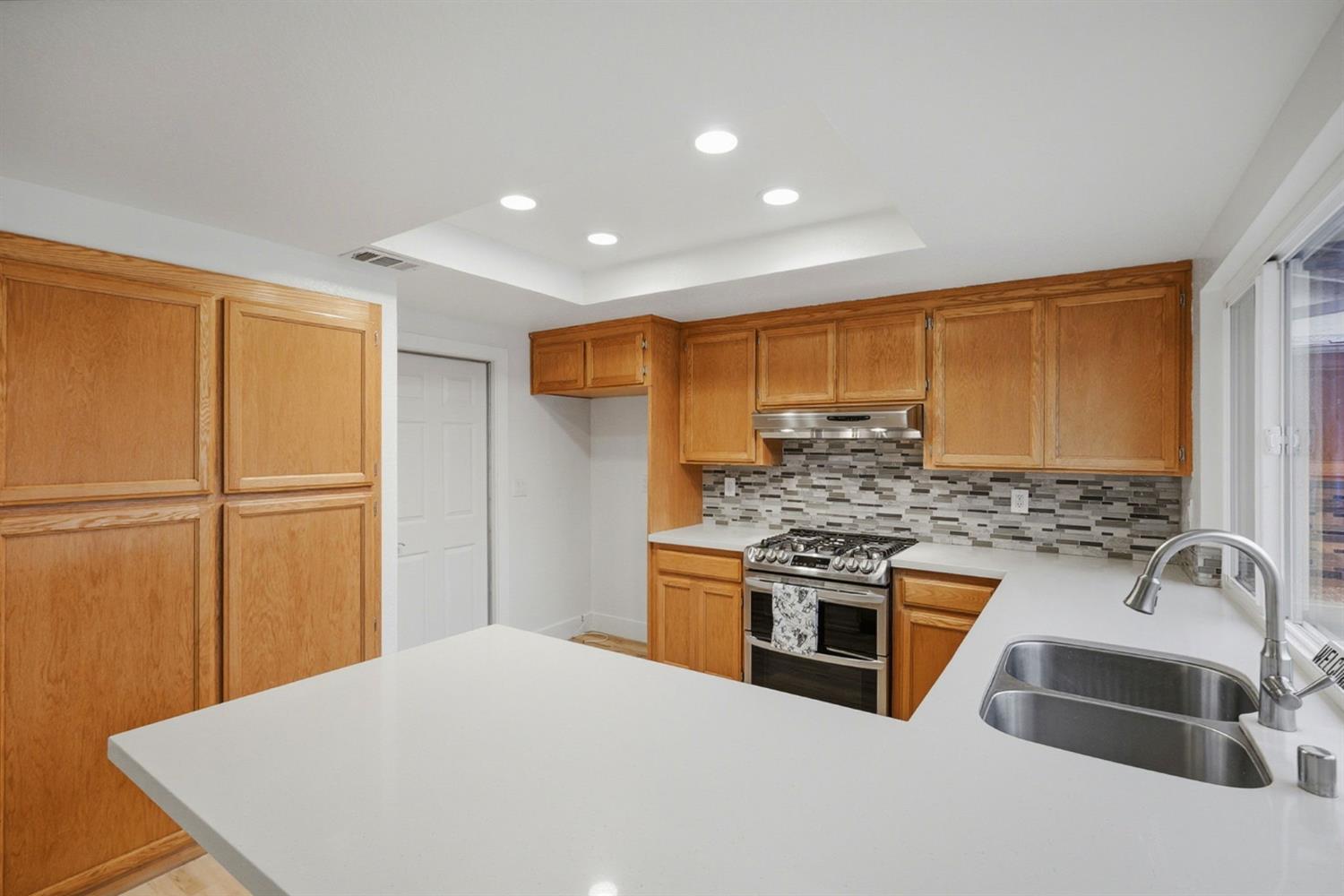 5932 Angelo Drive Loomis, CA 95650 - Photo 14 of 32 a kitchen with a stove a sink and a refrigerator