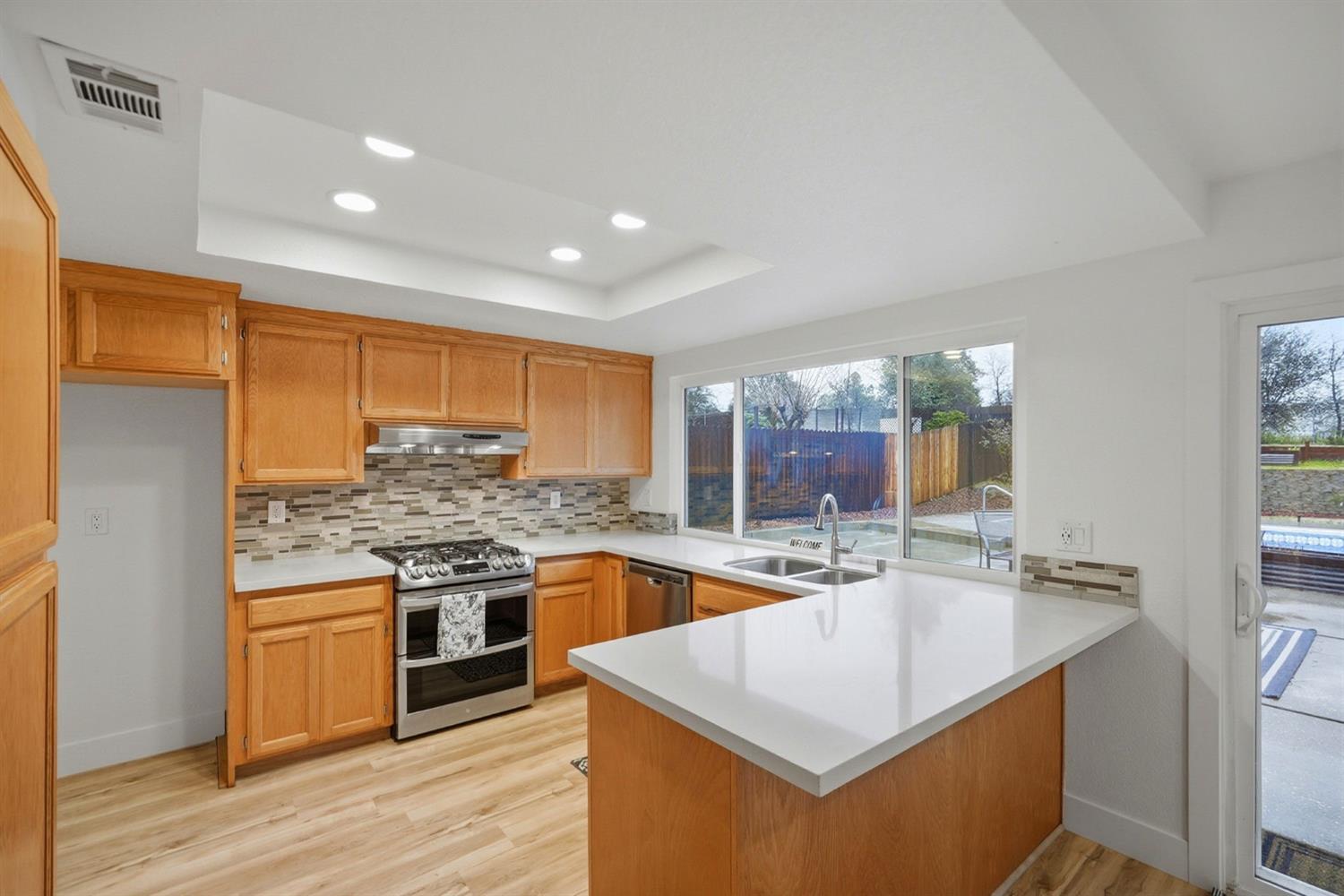 5932 Angelo Drive Loomis, CA 95650 - Photo 15 of 32 a kitchen with stainless steel appliances granite countertop a stove and a sink